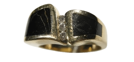 A gold ring with black and white stones on it.
