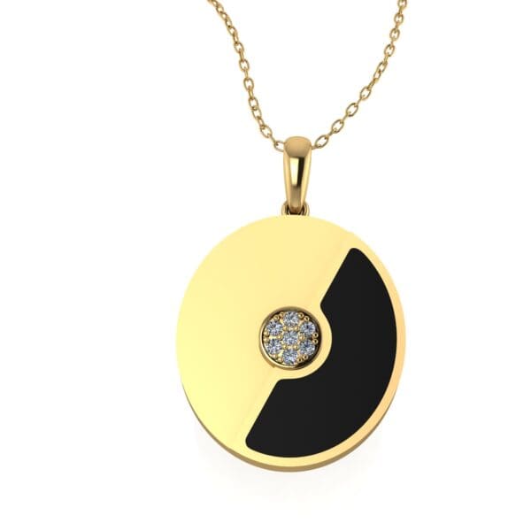 A gold necklace with black and white pendant