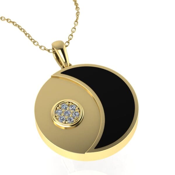 A gold necklace with a black and white pendant