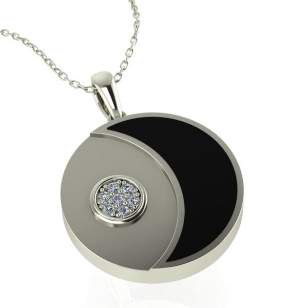 A silver necklace with a black and white pendant