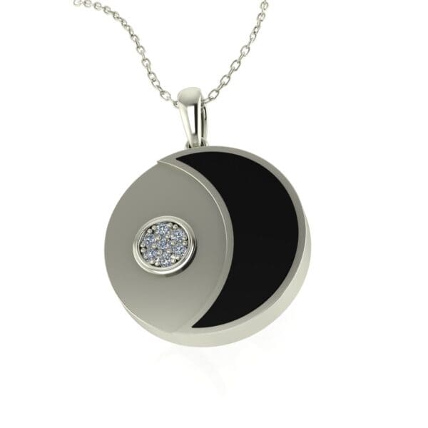 A silver necklace with a black and white pendant.