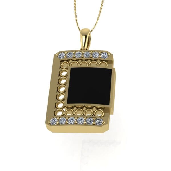 A gold necklace with a black and white pendant.