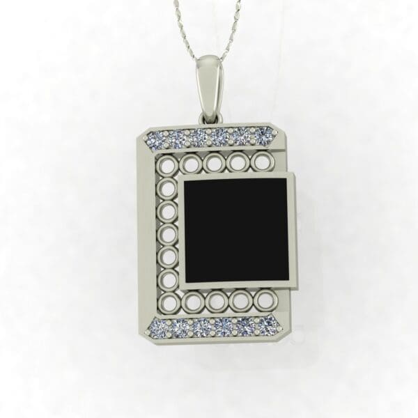 A silver necklace with a black and white pendant.
