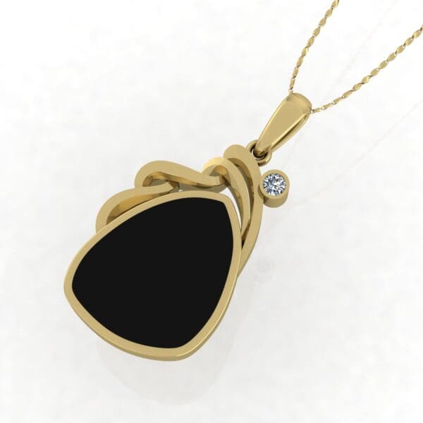 A gold necklace with black stone and diamond.