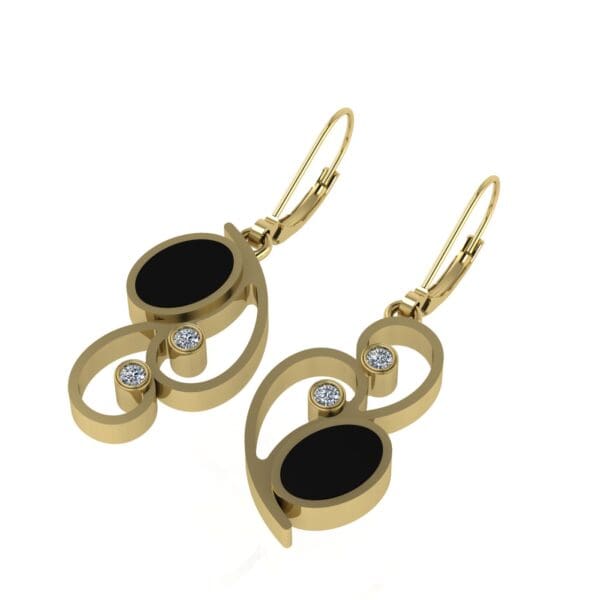 A pair of gold earrings with black and white stones.