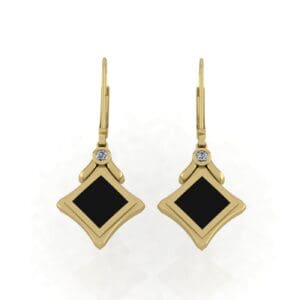 A pair of gold earrings with black and white stones.