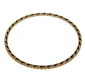 A gold colored metal ring with a pattern on it.